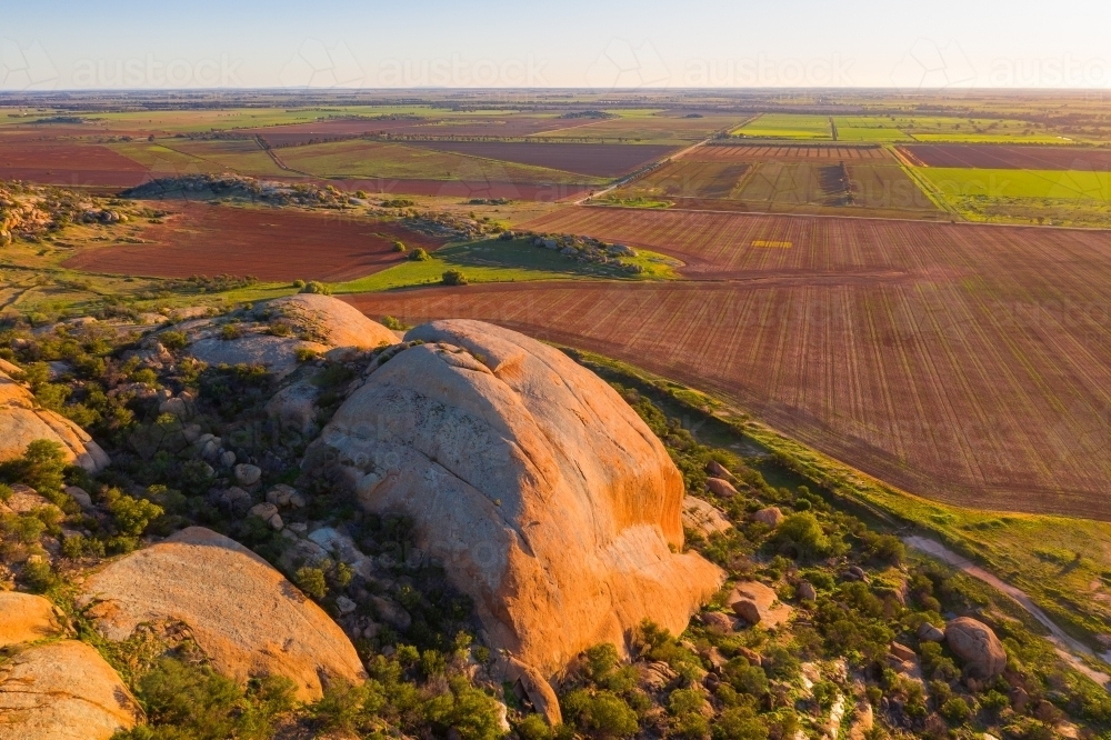 Image of Aerial view of a large granite mountain in late evening