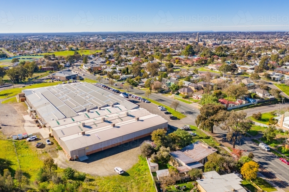 Aerial view of a large warehouse on the edge of a regional city - Australian Stock Image