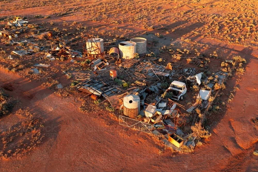 Aerial view of a outback scrap yard in a red desert landscape - Australian Stock Image