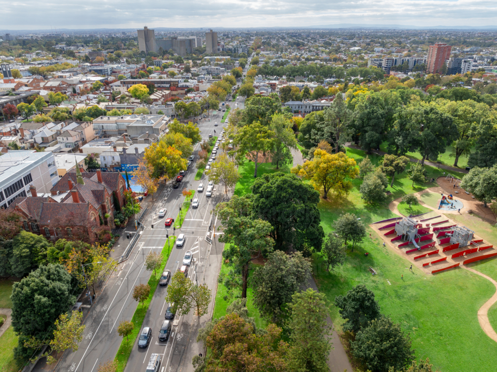 Aerial view of a playground in an inner city park and urban streetscape - Australian Stock Image