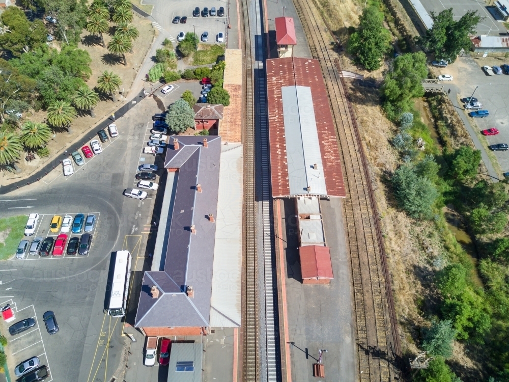 Aerial view of a railway station and platforms along a railway line - Australian Stock Image