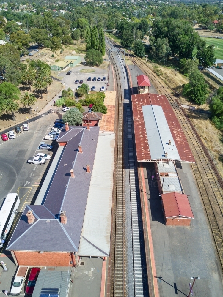 Aerial view of a railway station and platforms along a railway line - Australian Stock Image