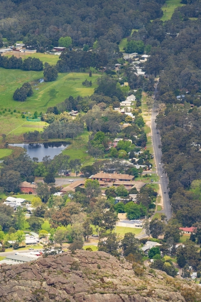Aerial view of a regional town nestled in a tree lined valley - Australian Stock Image