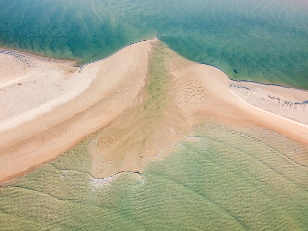 Aerial view of a river flowing over a sandbar and out to sea - Australian Stock Image