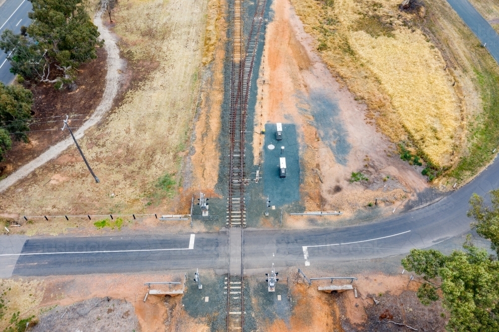 Aerial view of a road crossing a regional railway line - Australian Stock Image