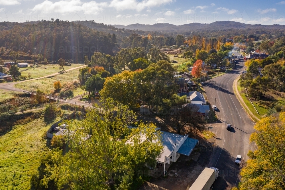 Aerial view of a road curving through a country town in Autumn - Australian Stock Image