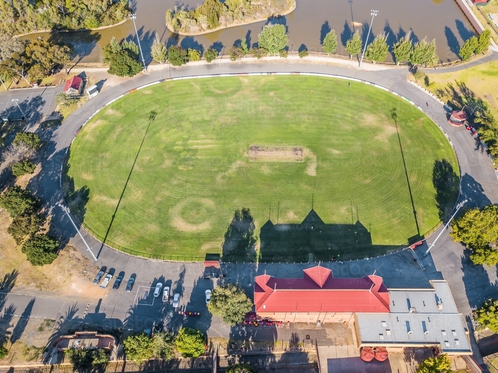 Image of Aerial view of a road surrounding a football oval and grandstand Austockphoto