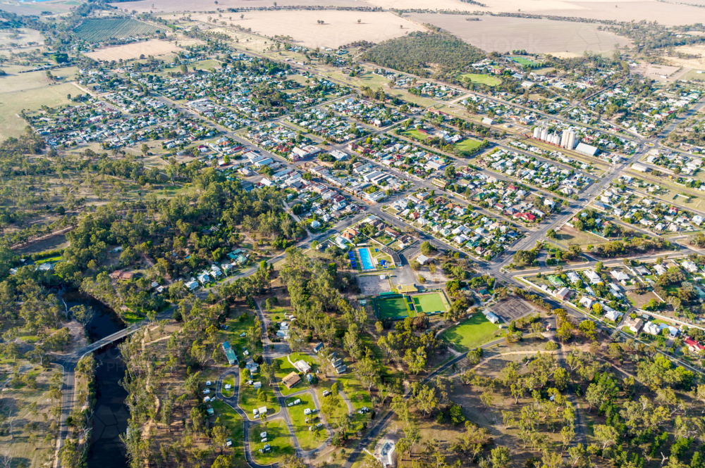 Aerial view of a rural township surrounded by open farmland and scattered bushland - Australian Stock Image