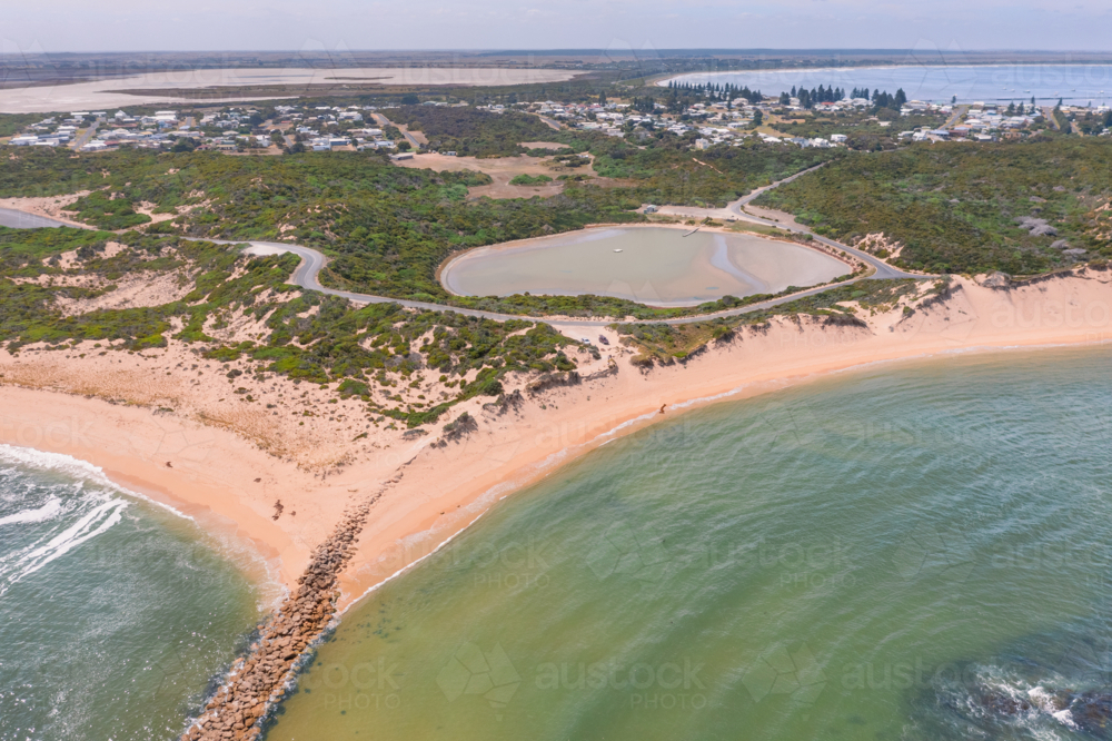 Aerial view of a salt lake circled by roads behind beaches on a sandy coastline - Pool of Siloam - Australian Stock Image