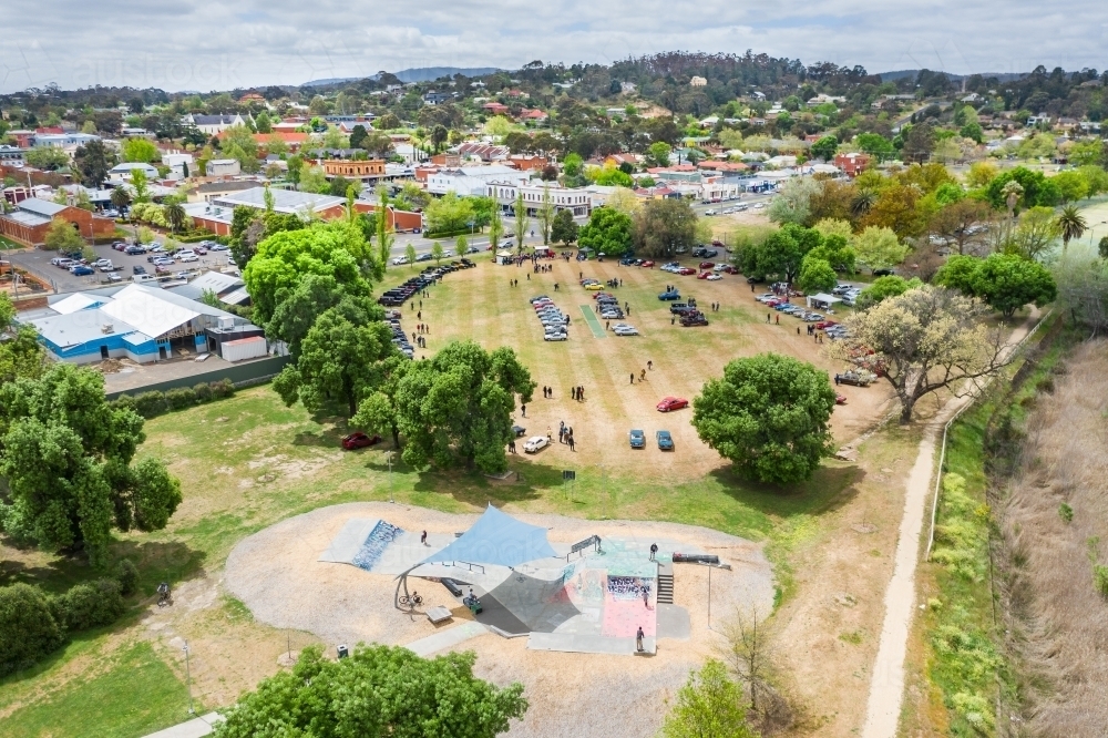 Aerial view of a skate park and car rally on a country town cricket oval - Australian Stock Image