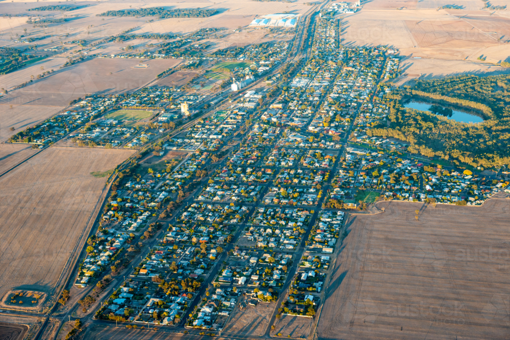 Aerial view of a small rural town showing grid streets surrounded by open agricultural farmland - Australian Stock Image