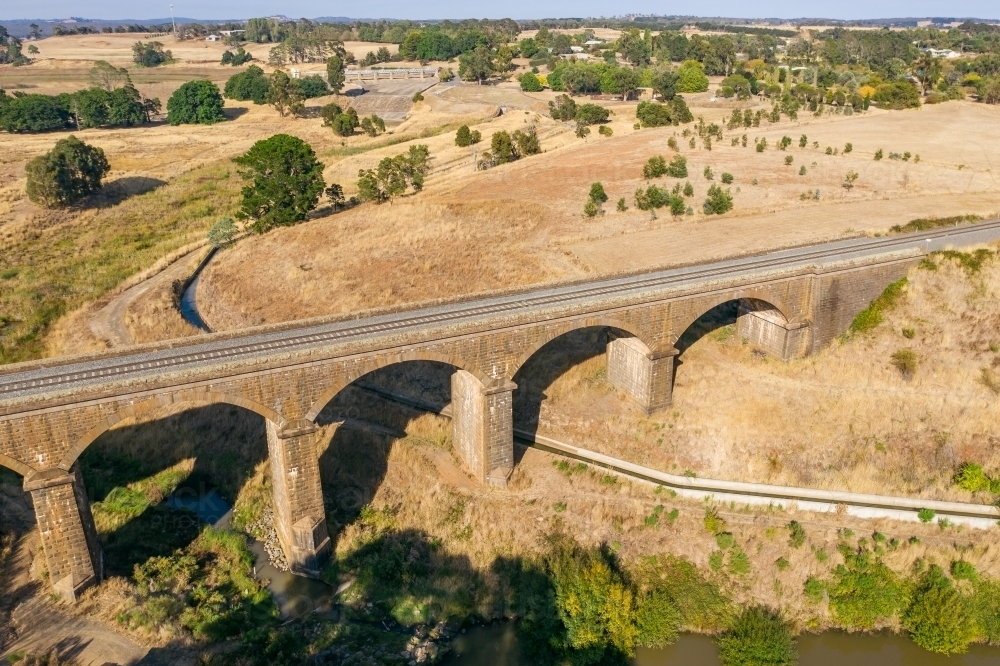 Aerial view of a stone viaduct over a river and water channel - Australian Stock Image