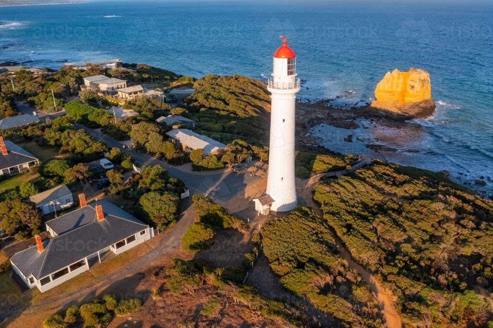 Image of Aerial view of a tall white lighthouse high on a hill top in ...