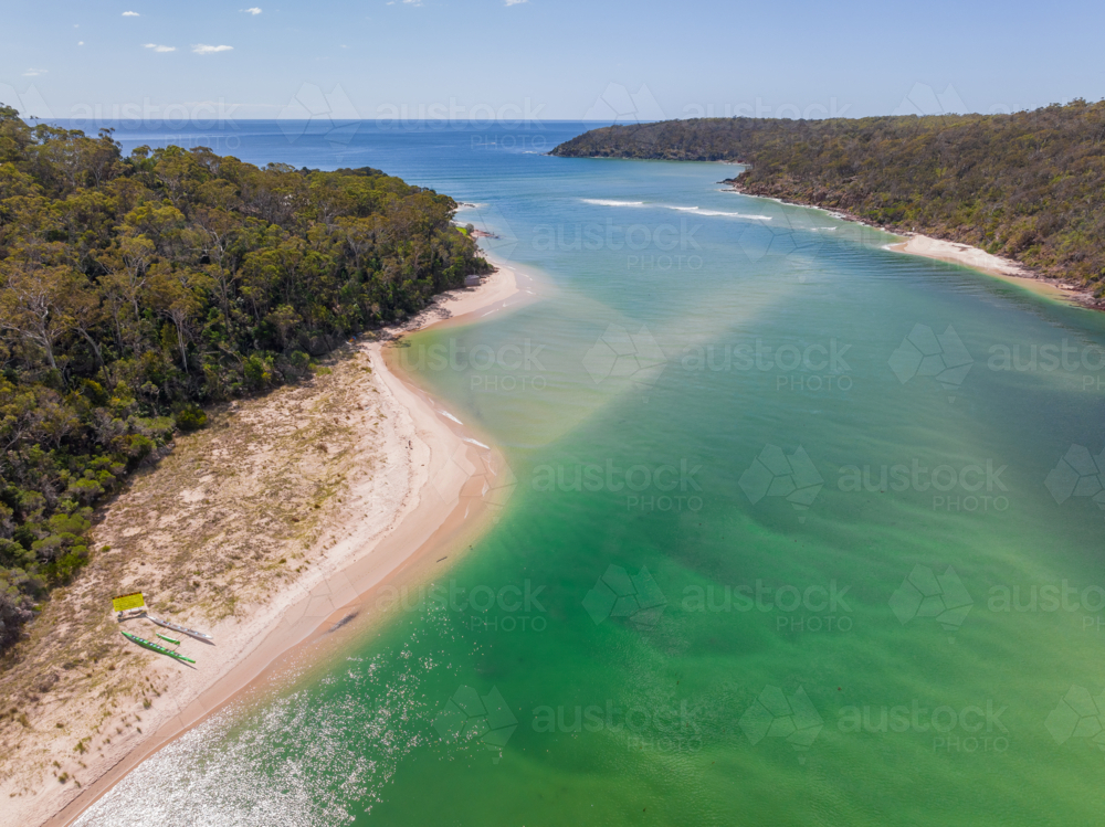 Image of Aerial view of a wide coastal river with forest on both banks ...