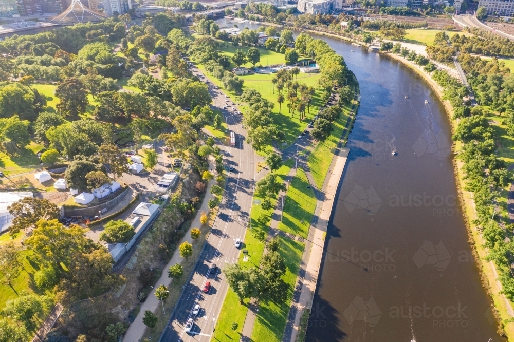 Aerial view of a wide river with parkland and a road along side - Australian Stock Image