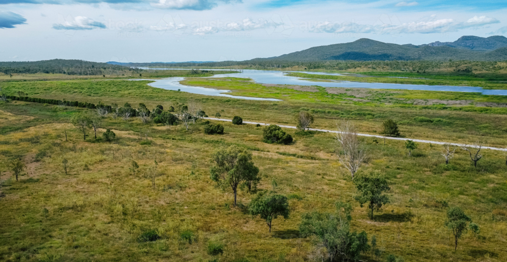 Aerial view of a winding river cutting through a lush, green landscape - Australian Stock Image