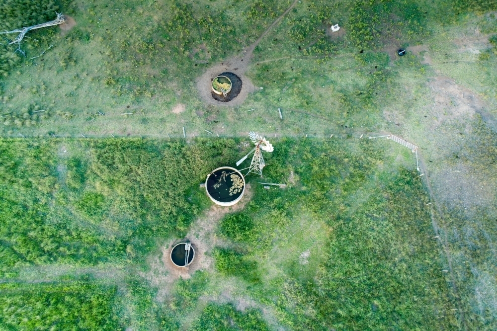 Aerial view of a windmill and water troughs. - Australian Stock Image