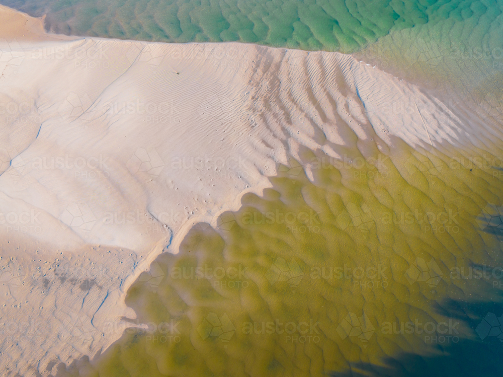 Image of Aerial view of abstract pattern and water flow over sand in a ...