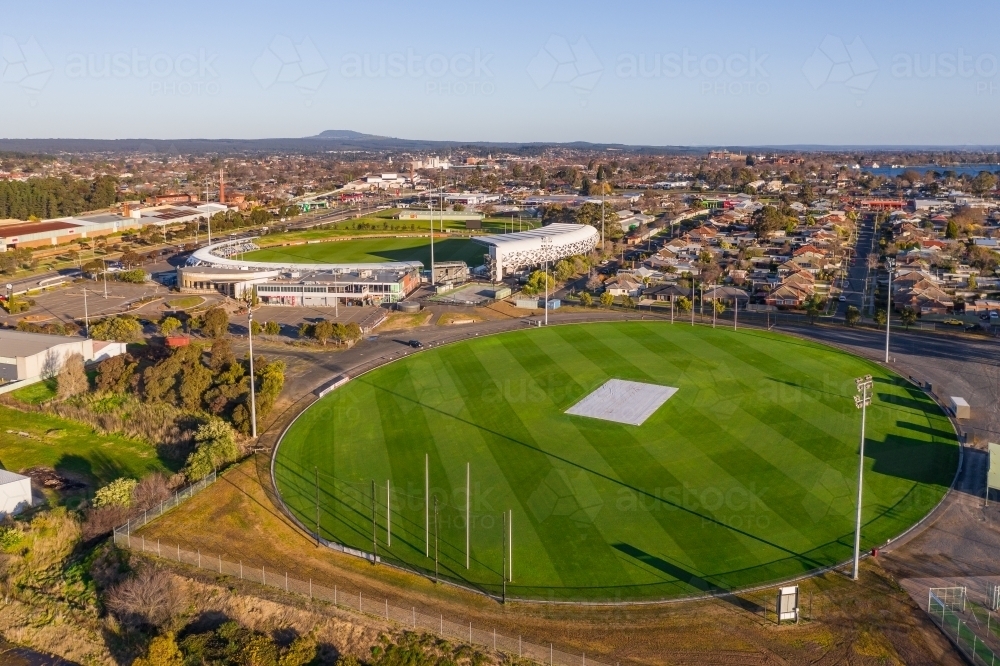 Aerial view of AFL football ovals amongst suburban housing - Australian Stock Image