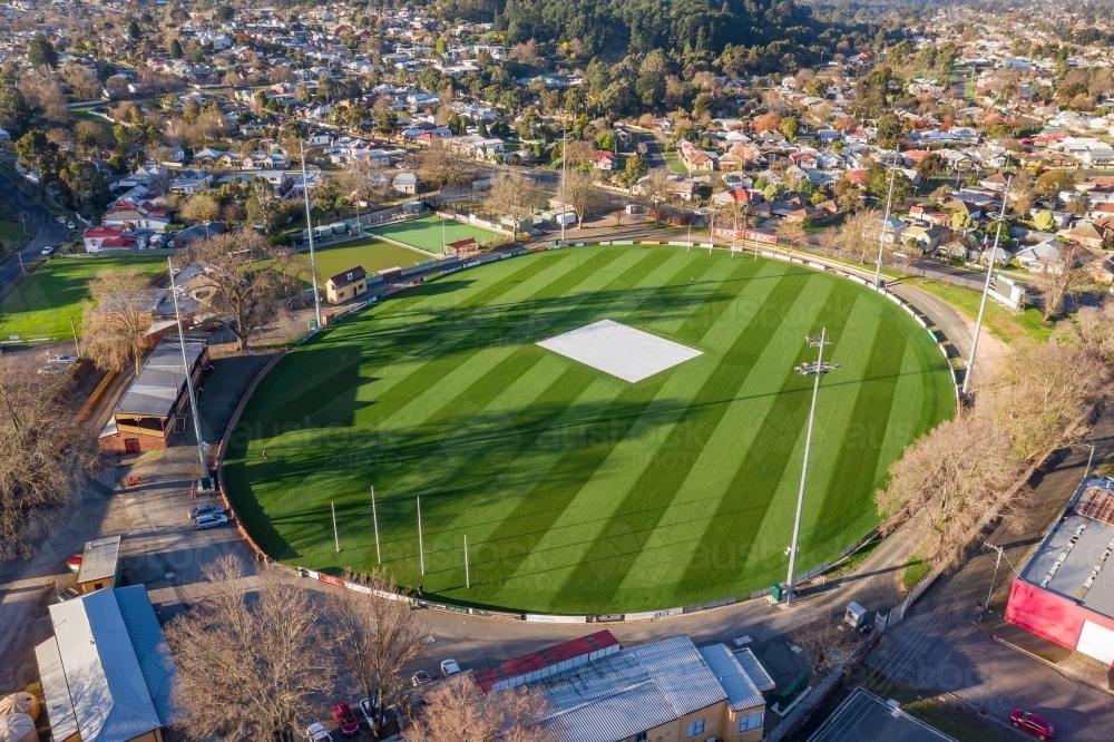 Aerial view of an AFL football oval amongst suburban housing - Australian Stock Image
