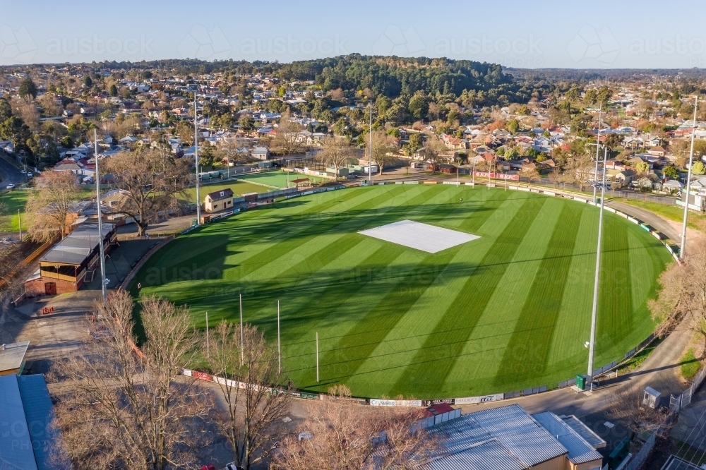 Aerial view of an AFL football oval amongst suburban housing - Australian Stock Image