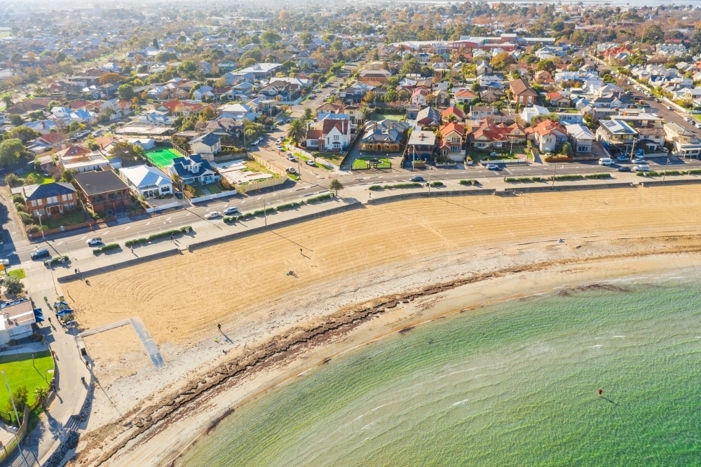 Aerial view of an inner city beach surrounded by suburban housing - Australian Stock Image