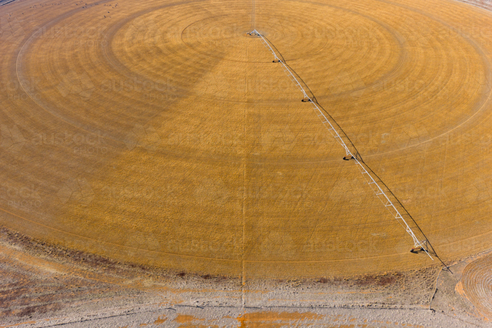 Aerial view of an irrigation sprinkler on a circular crop - Australian Stock Image