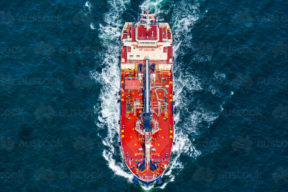 Aerial view of an oil tanker navigating through deep blue ocean waters on Sydney Harbour - Australian Stock Image