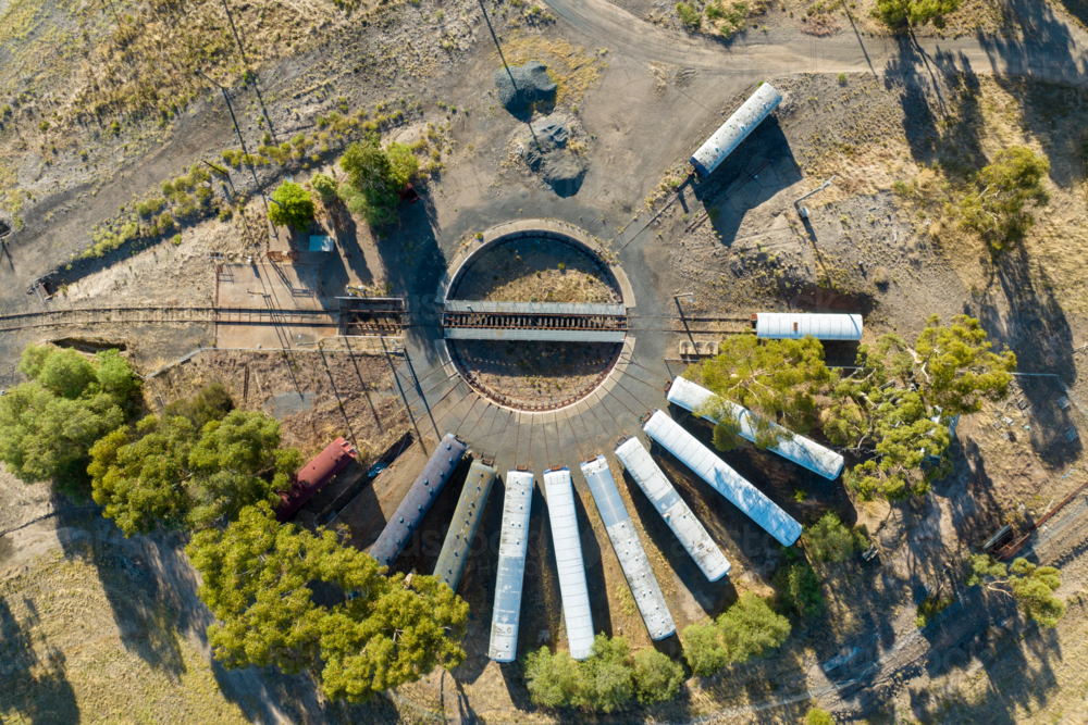 Aerial view of an old railway turntable with abandoned train carriages. - Australian Stock Image