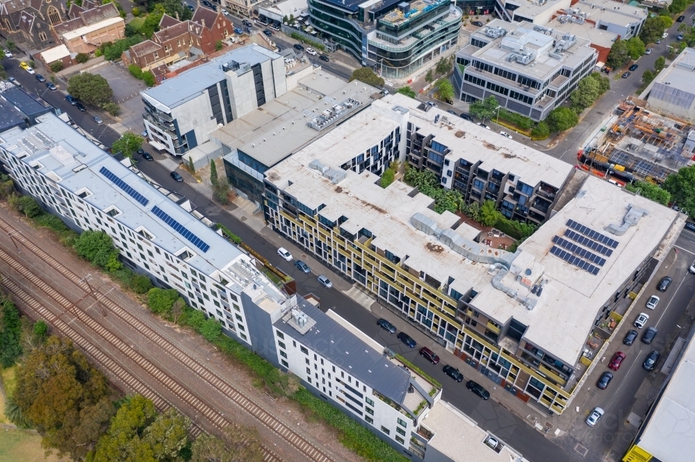 Aerial view of apartment blocks along an inner city railway line - Australian Stock Image