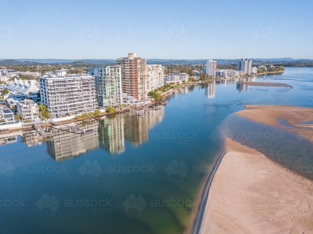 Aerial view of apartment buildings along the sides of the Maroochy River . - Australian Stock Image