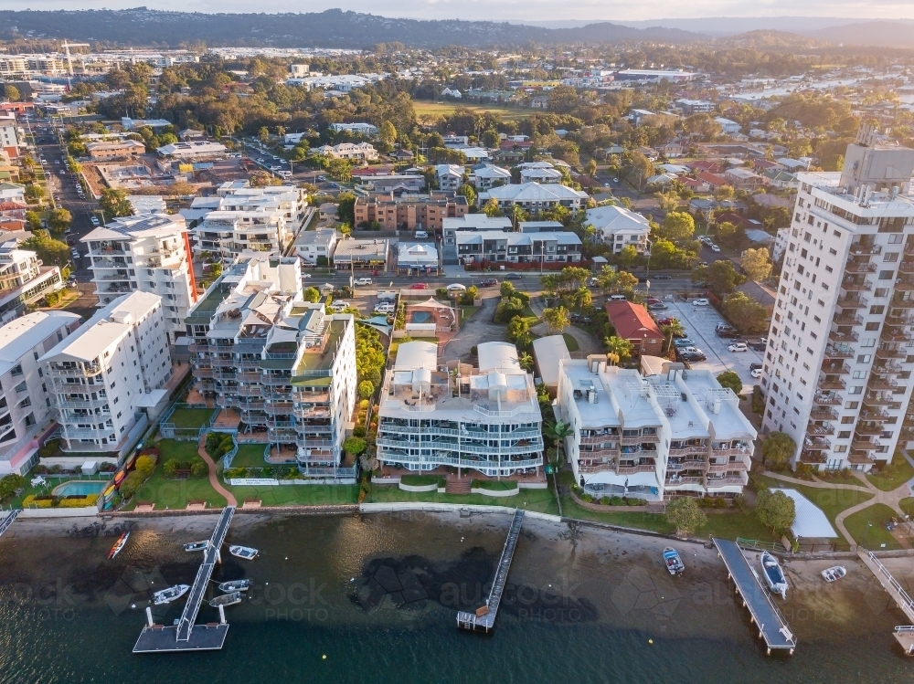Image of Aerial view of apartment buildings and jetties along the banks