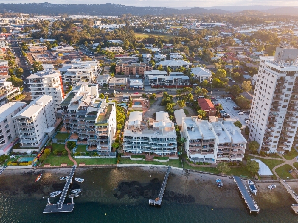 Aerial view of apartment buildings and jetties along the banks of the Maroochy River in Queensland. - Australian Stock Image