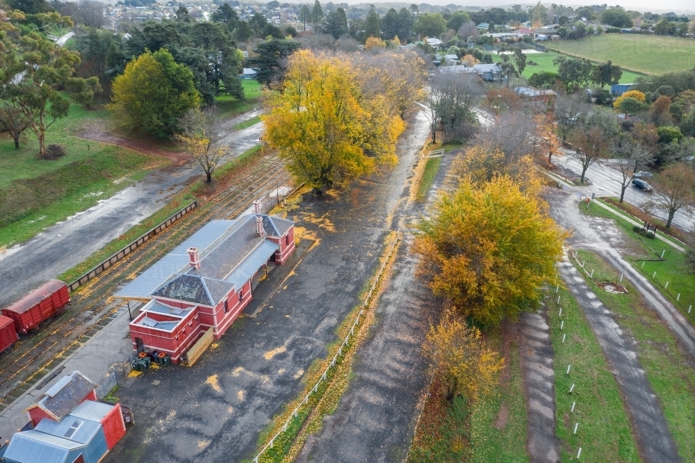Aerial view of autumn trees surrounding an historic railways - Australian Stock Image