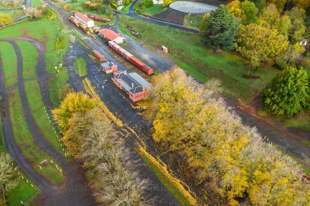 Aerial view of autumn trees surrounding an historic railways - Australian Stock Image