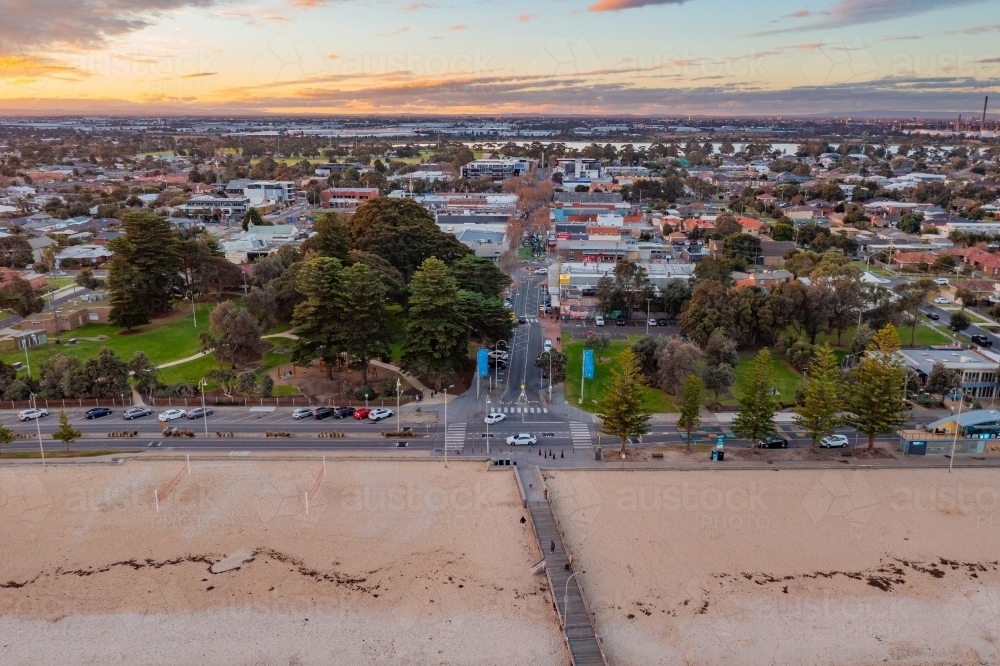 Aerial view of bay side beach suburb and esplanade at dusk - Australian Stock Image