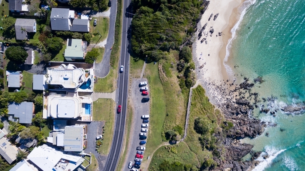 Aerial view of beachfront houses and coastline. - Australian Stock Image