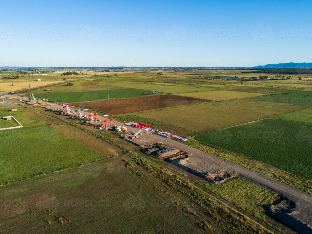 Aerial view of beginnings of bypass highway road under construction in farmland - Australian Stock Image