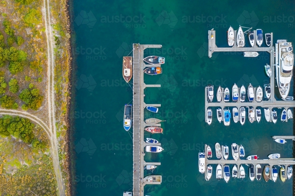 Image of Aerial view of boats and yachts anchored along jettys at a ...
