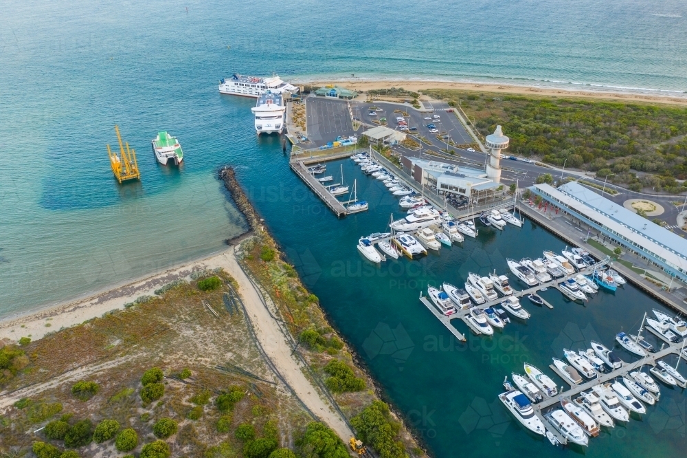 Image of Aerial view of boats and yachts anchored along jettys at a ...