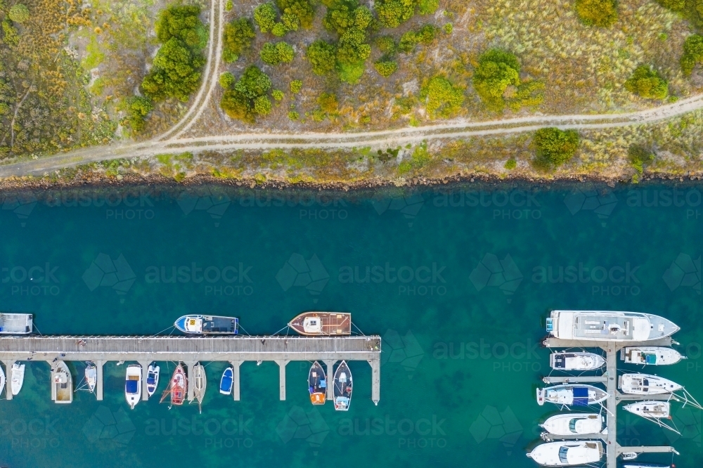 Image of Aerial view of boats and yachts anchored along jettys at a ...