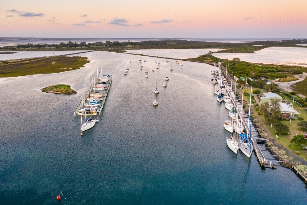 Image of Aerial view of boats and yachts anchored along jettys at a ...