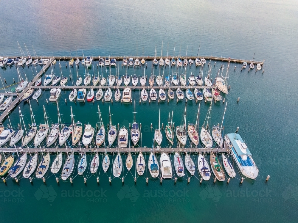 Image of Aerial view of boats and yachts moored at a marina - Austockphoto