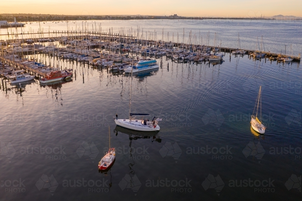 Image of Aerial view of boats at a marina at sunset - Austockphoto