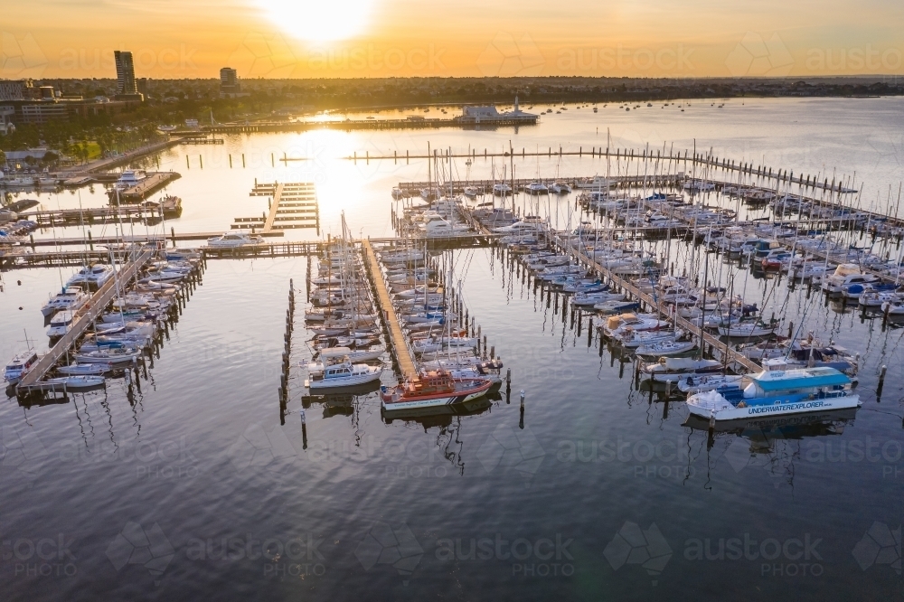 Image of Aerial view of boats at a marina at sunset - Austockphoto