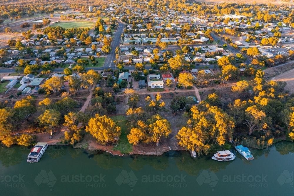 Image of Aerial view of boats moored on a river bank alongside a ...