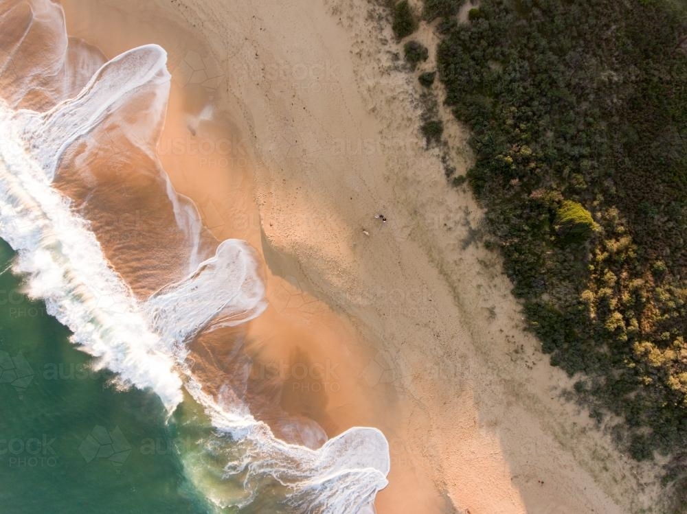 Aerial view of breaking wave washing on a sandy Beach - Australian Stock Image