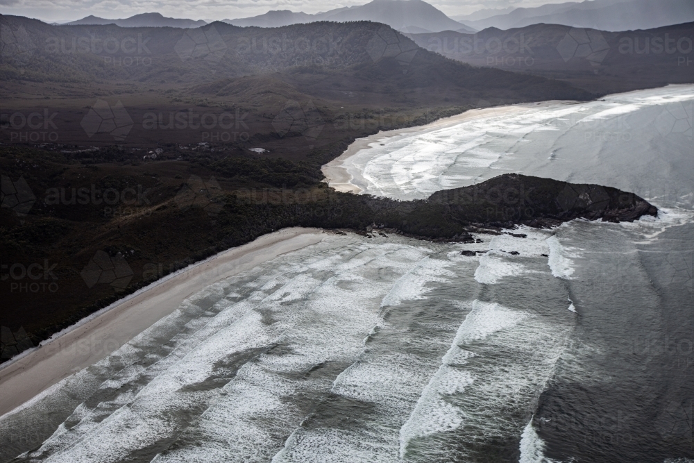 Aerial view of breaking waves and coastline at Cox Bight, South West Tasmania - Australian Stock Image