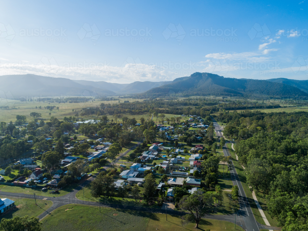 Aerial view of Broke village in silvery morning light with houses and hazy hills - Australian Stock Image