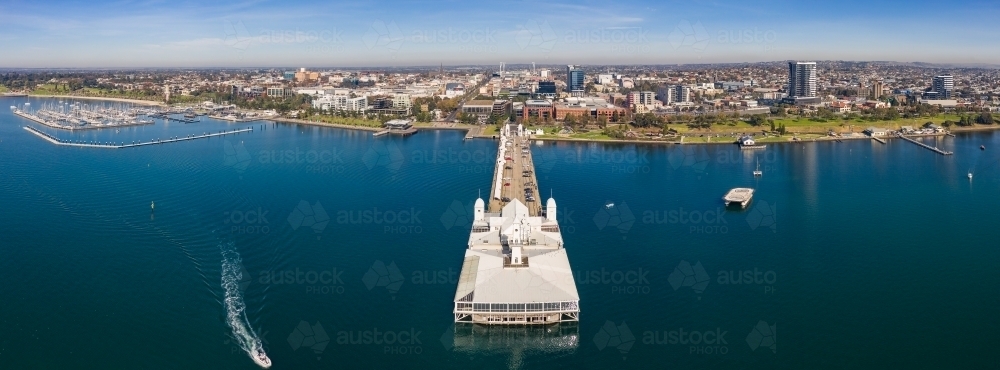 Aerial view of buildings on the end of a long jetty out over a coastal bay - Australian Stock Image